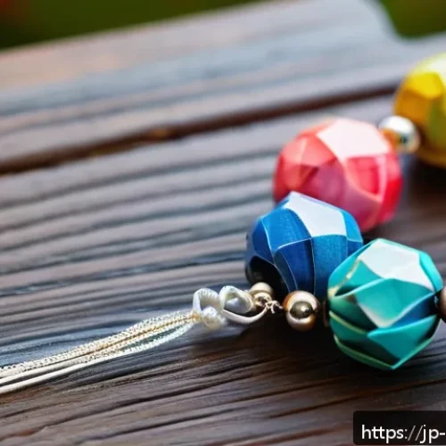 종이 비즈 만들기 - A close-up shot of handmade paper bead jewelry crafted from glossy wrapping paper, showcasing triang...